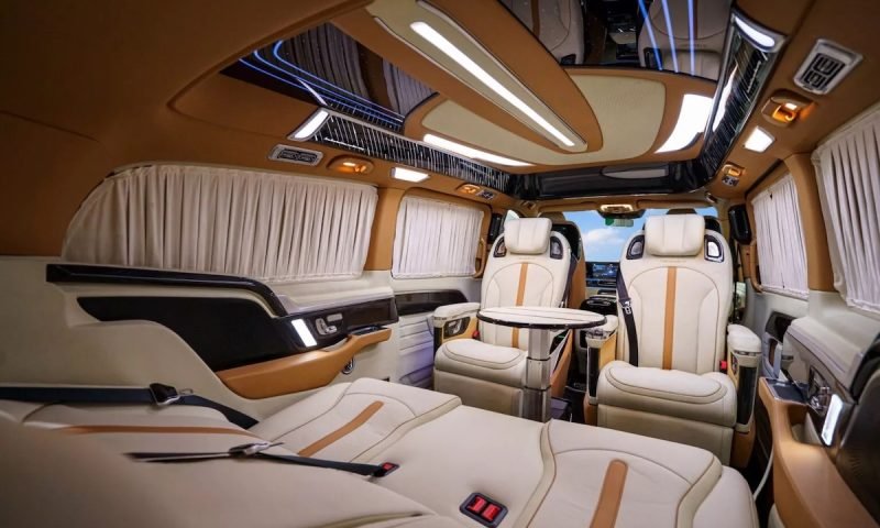 Mansory customized luxury van interior with reclining seats, ambient lighting, and premium leather finish