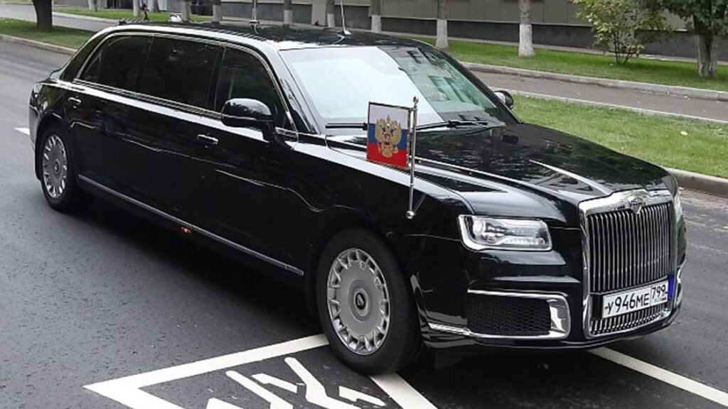 Aurus Senat limousine from Vladimir Putin car collection, a black armored luxury state car with Russian flag on the front.