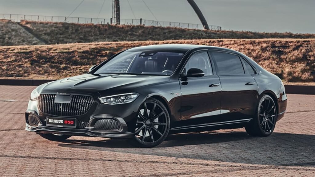 A glossy black luxury sedan, the Brabus 850, featuring a custom black vertical-slat grille and multi-spoke black wheels, parked outdoors on asphalt.