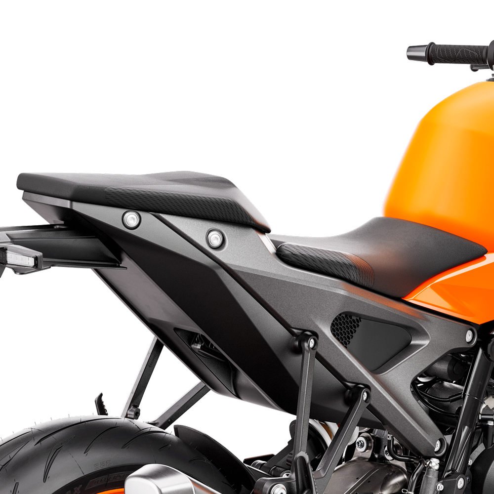 Close-up of the black rider and pillion seat area on a bright orange KTM Duke 990 motorcycle.