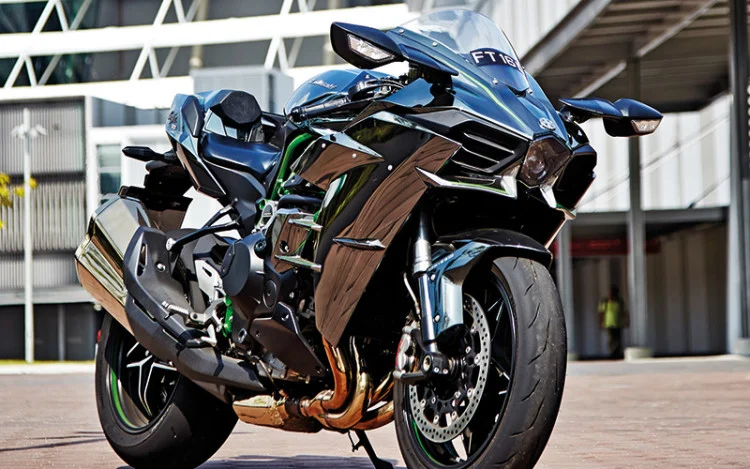 Full-view photo of the supercharged Kawasaki Ninja H2, showcasing its mirror-coated black paint and aggressive fairing.
