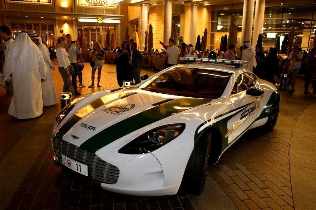 Dubai Police cars featuring an Aston Martin One-77 supercar on city patrol, highlighting luxury design, exclusivity, and high-performance policing in Dubai