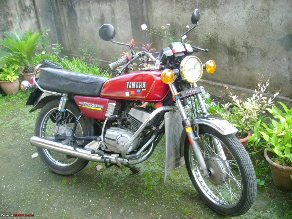 Cars and bikes vintage legend showing a classic Yamaha RX100 motorcycle, highlighting retro bike design, lightweight performance, and cult popularity among cars and bikes enthusiasts